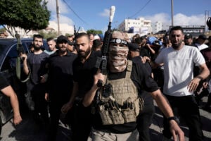 Gunmen attend the funeral of five Palestinians killed in an Israeli airstrike in Tubas, West Bank, Thursday, Sept. 5, 2024. Palestinian health officials say Israeli strikes in the occupied West Bank killed five people. Israel has been carrying out large-scale raids in the territory over the past week that it says are aimed at dismantling militant groups and preventing attacks. (AP Photo/Majdi Mohammed).