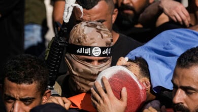 Mourners, some armed, carry the bodies of five Palestinians during their funeral in Tubas, West Bank, Thursday, Sept. 5, 2024. Palestinian health officials say Israeli strikes in the occupied West Bank killed five people. Israel has been carrying out large-scale raids in the territory over the past week that it says are aimed at dismantling militant groups and preventing attacks. (AP Photo/Majdi Mohammed).