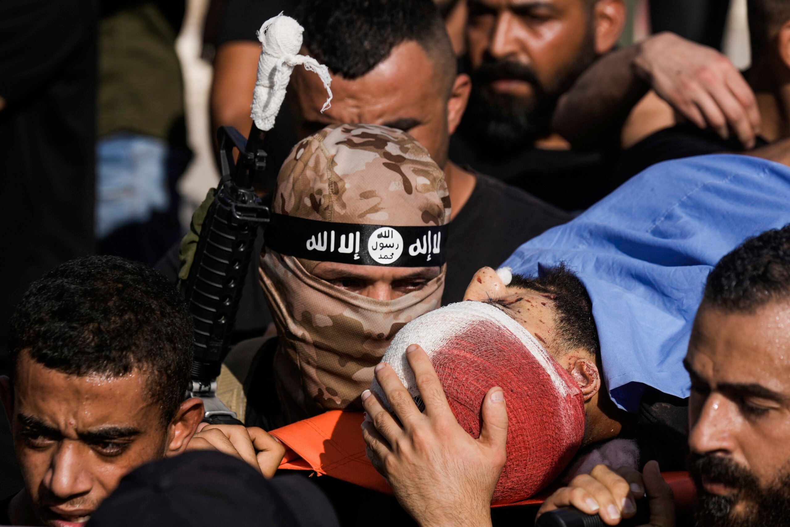 Mourners, some armed, carry the bodies of five Palestinians during their funeral in Tubas, West Bank, Thursday, Sept. 5, 2024. Palestinian health officials say Israeli strikes in the occupied West Bank killed five people. Israel has been carrying out large-scale raids in the territory over the past week that it says are aimed at dismantling militant groups and preventing attacks. (AP Photo/Majdi Mohammed).