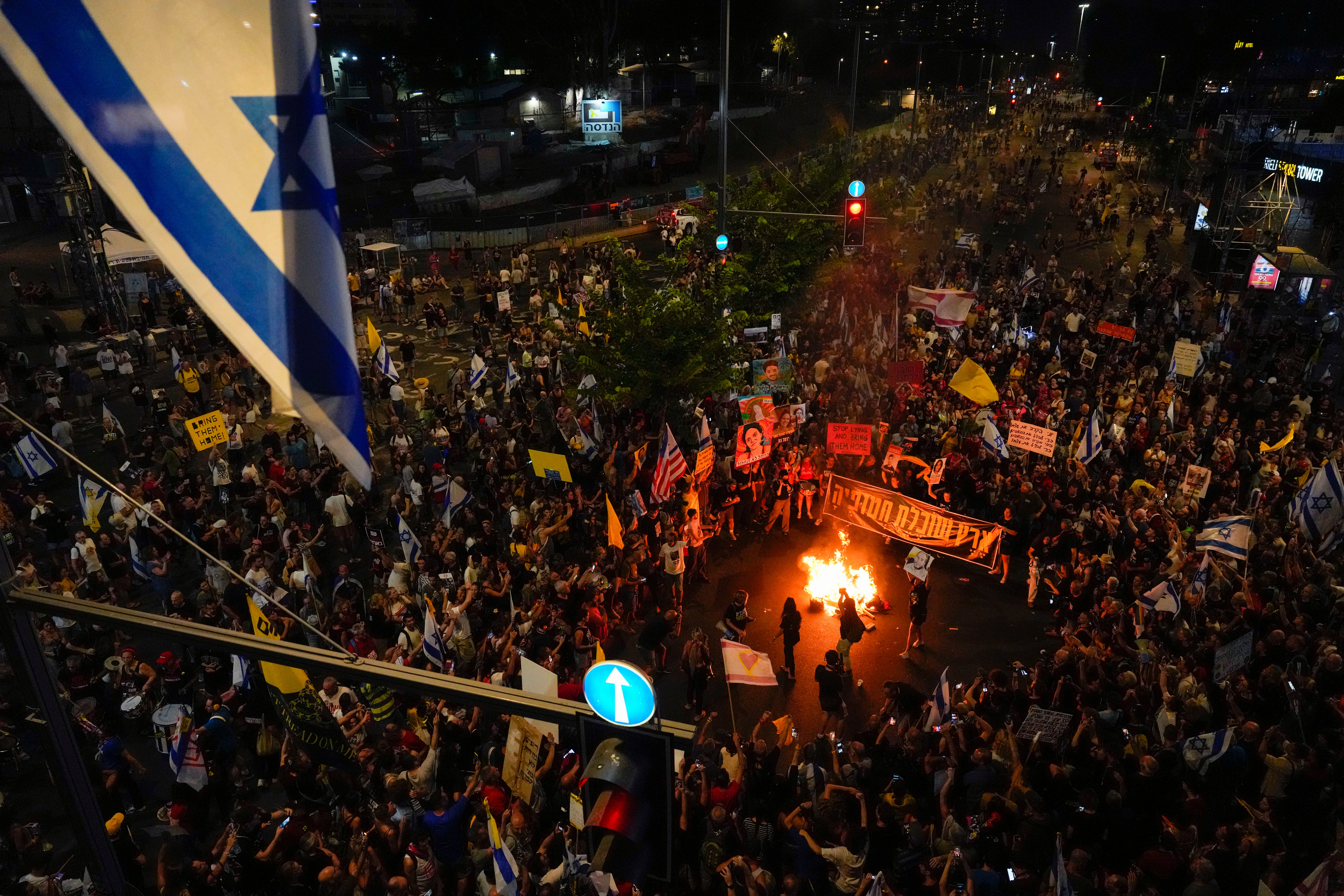 People protest against Prime Minister Benjamin Netanyahu's government and call for the release of hostages held in the Gaza Strip by the Hamas militant group, in Tel Aviv, Israel, Saturday, Sept. 7, 2024. (AP Photo/Ariel Schalit).