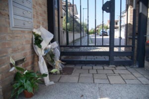 Flowers in front of the gate near the scene of the triple homicide in Milan, Monday, Sept. 2, 2024.  Claudio Furlan/LaPresse via AP).