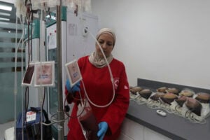 A Lebanese Red Cross volunteer collects blood donations for those who were injured by their exploded handheld pagers, Tuesday, Sept. 17, 2024, at a Red Cross center in the southern port city of Sidon, Lebanon. (AP Photo/Mohammed Zaatari).