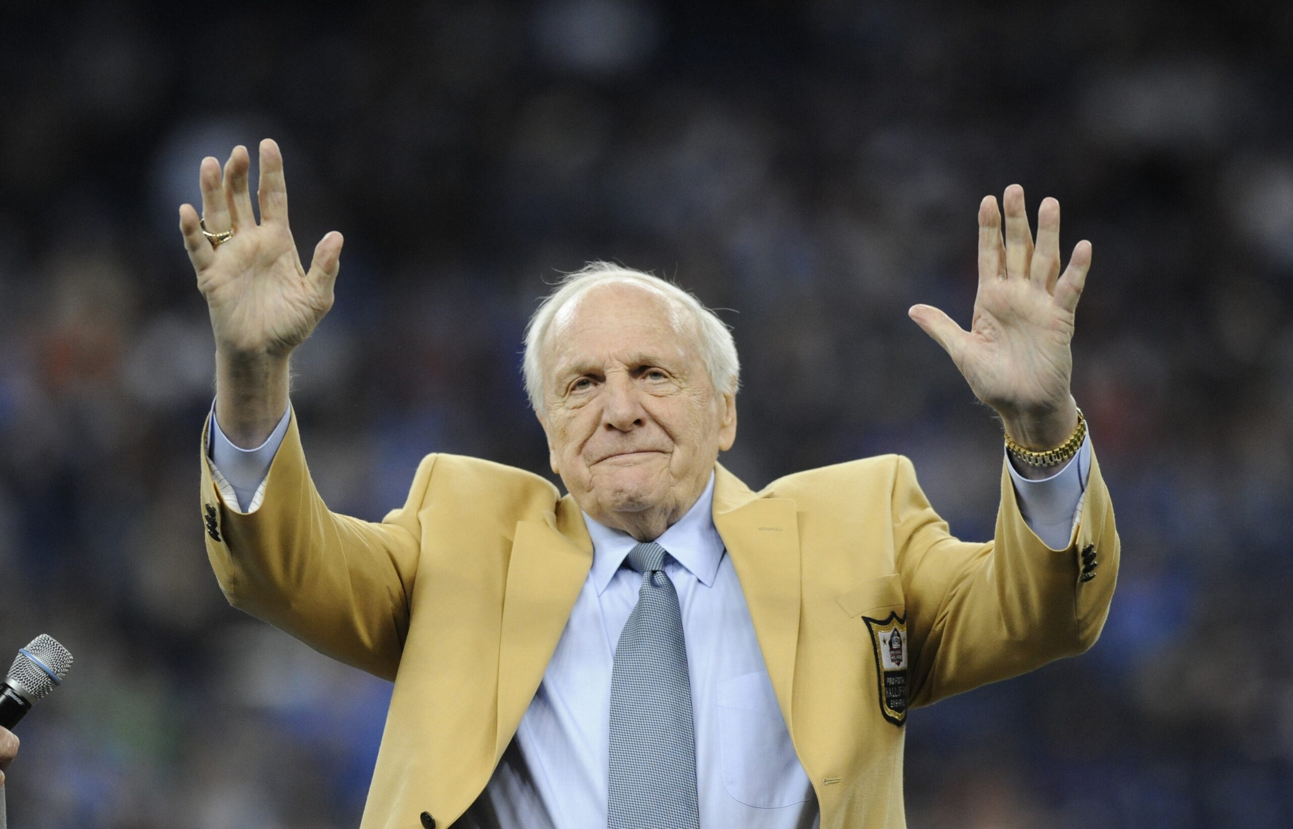 Detroit Lions head coach Joe Schmidt acknowledges the crowd after receiving a Pro Football Hall of Fame ring during a ceremony at halftime of an NFL football game between the Detroit Lions and the Chicago Bears, Oct. 18, 2015, in Detroit. (AP Photo/Jose Juarez, File).