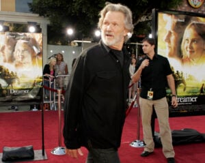 Actor Kris Kristofferson walks down the red carpet during the premiere for his new movie "Dreamer," Oct. 9, 2005, in the Westwood section of Los Angeles. (AP Photo/Ric Francis, File).