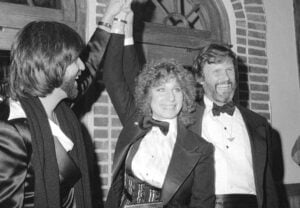 Producer Jon Peters, from left, Barbra Streisand and Kris Kristofferson appear at a preview of the film, "A Star is Born," in Dec. 23, 1976, in New York. Kristofferson, a Rhodes scholar with a deft writing style and rough charisma who became a country music superstar and A-list Hollywood actor, has died Saturday, Sept. 28, 2024. (AP Photo/Suzanne Vlamis, File).