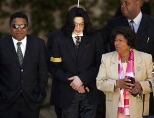 Pop star Michael Jackson, center, his mother Katherine Jackson, right, and brother Tito Jackson, left, leave Santa Barbara County Superior Court in Santa Maria, Calif., April 7, 2005, after another day of testimony in Michael Jackson's child molestation trial. (AP Photo/Kevork Djansezian, File).