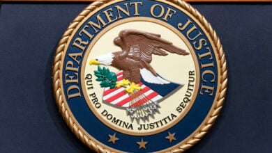 The Department of Justice seals is seen during a news conference at the DOJ office in Washington, May 16, 2023. (AP Photo/Jose Luis Magana, File).