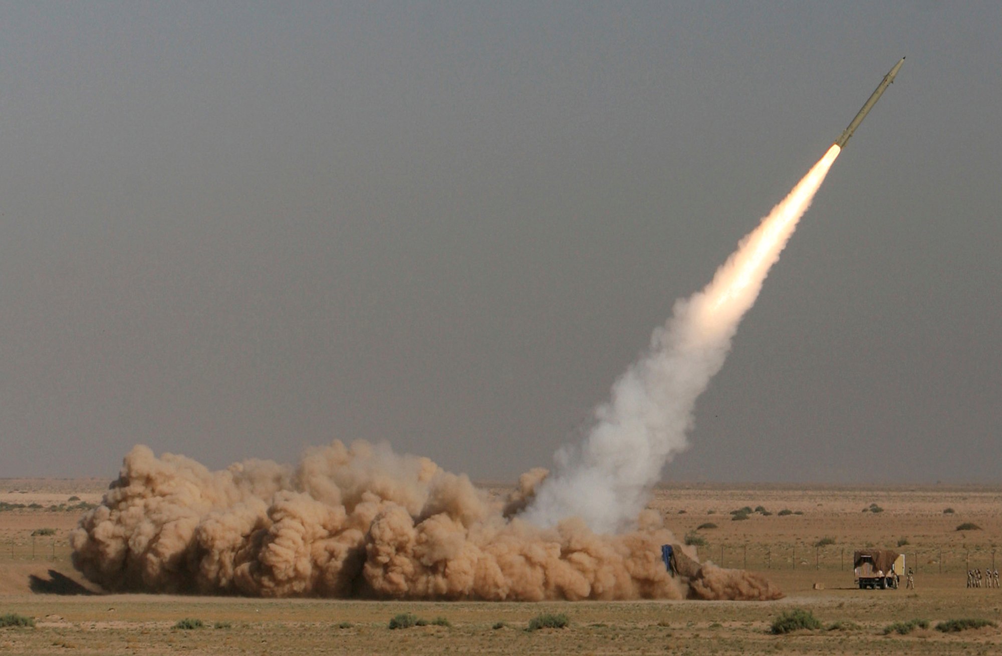 In this photo released by the Iranian semi-official Fars News Agency, Revolutionary Guard's Fateh missile is launched in a drill near the city of Qom, 80 miles (130 kilometers) south of the capital Tehran, Iran, Sept. 27, 2009. (Ali Shaigan/Fars News Agency via AP File).