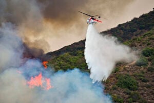 Firefighters battle the Airport Fire along Trabuco Creek Road in Trabuco Canyon, Calif., on Monday, Sept. 9, 2024. (Jeff Gritchen/The Orange County Register via AP).