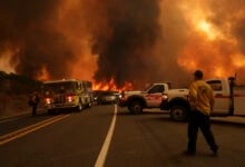 Firefighters monitor the Airport Fire as it advances Tuesday, Sept. 10, 2024, in El Cariso, an unincorporated community in Riverside County, Calif. (AP Photo/Eric Thayer).