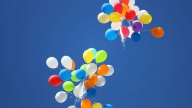 A man claims inhaling hundreds of laughing gas balloons weekly has left him with 'dinosaur hands'.