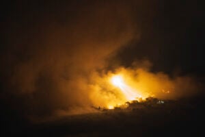 Israeli shelling hits an area in southern Lebanon as seen from northern Israel, early Tuesday, Oct. 1, 2024. (AP Photo/Leo Correa).