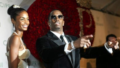 Sean "P. Diddy" Combs directs photographers as they sing "Happy Birthday," to him as his date Kim Porter, left, listens, after Combs arrived for his 35th birthday celebration at Cipriani on Wall Street in New York, Nov. 4, 2004. (AP Photo/Kathy Willens, File).