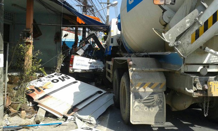 Cement truck takes out parked car, small restaurant