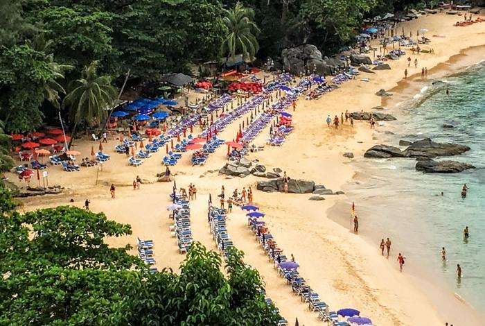 Phuket beach covered with umbrellas, chairs