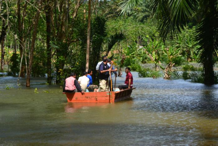 Floating officials visit flooded village