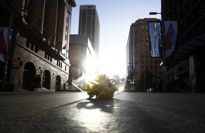 Police storm Sydney cafe to end hostage siege, three dead