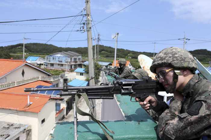 South Korea conscript who killed five comrades continues standoff with troops