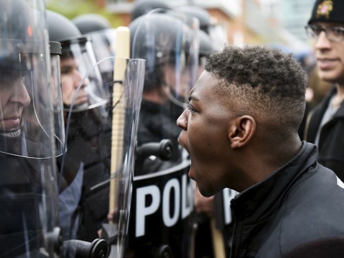 Thousands of police descend on Baltimore to enforce curfew after riots