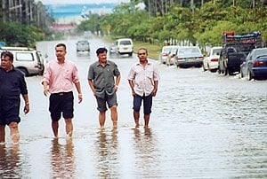 Officials inspect flooded thoroughfare