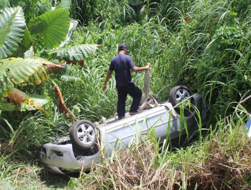 Phuket driver escapes injury as car flips, plunges into canal