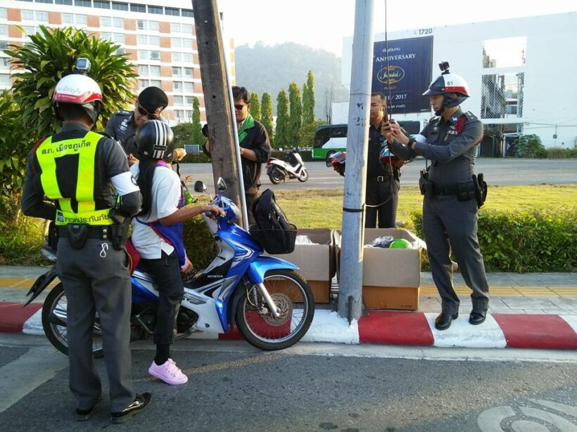 Traffic police giving away helmets to children in Phuket Town