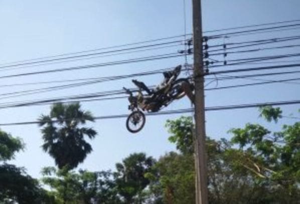 Flying motorbike ends up stuck in power lines in Surin