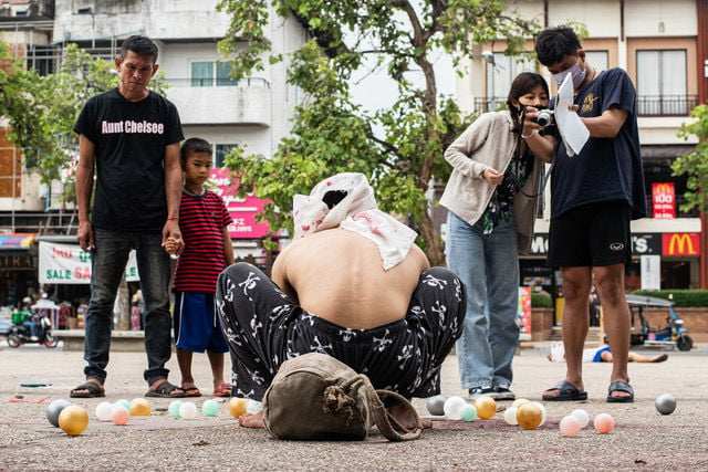 Chiang Mai protesters perform in pouring rain