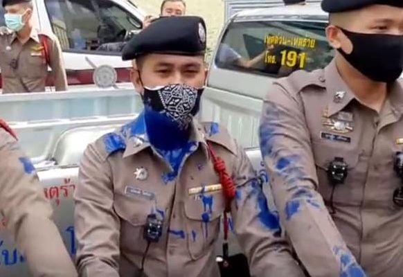 Protesters push through barricades at Bangkok police station