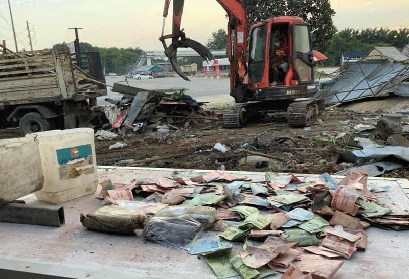 Backhoe driver digs up 100,000 baht in cash buried in Nakhon Si Thammarat