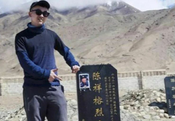 Travel blogger jailed in China for posing with a veteran’s tombstone for pictures