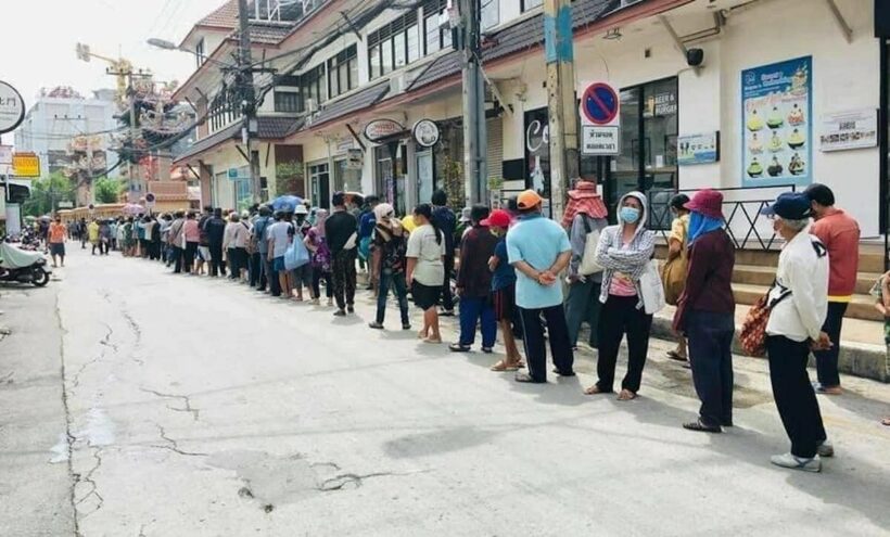 Hundreds queue for free food handouts in Pattaya