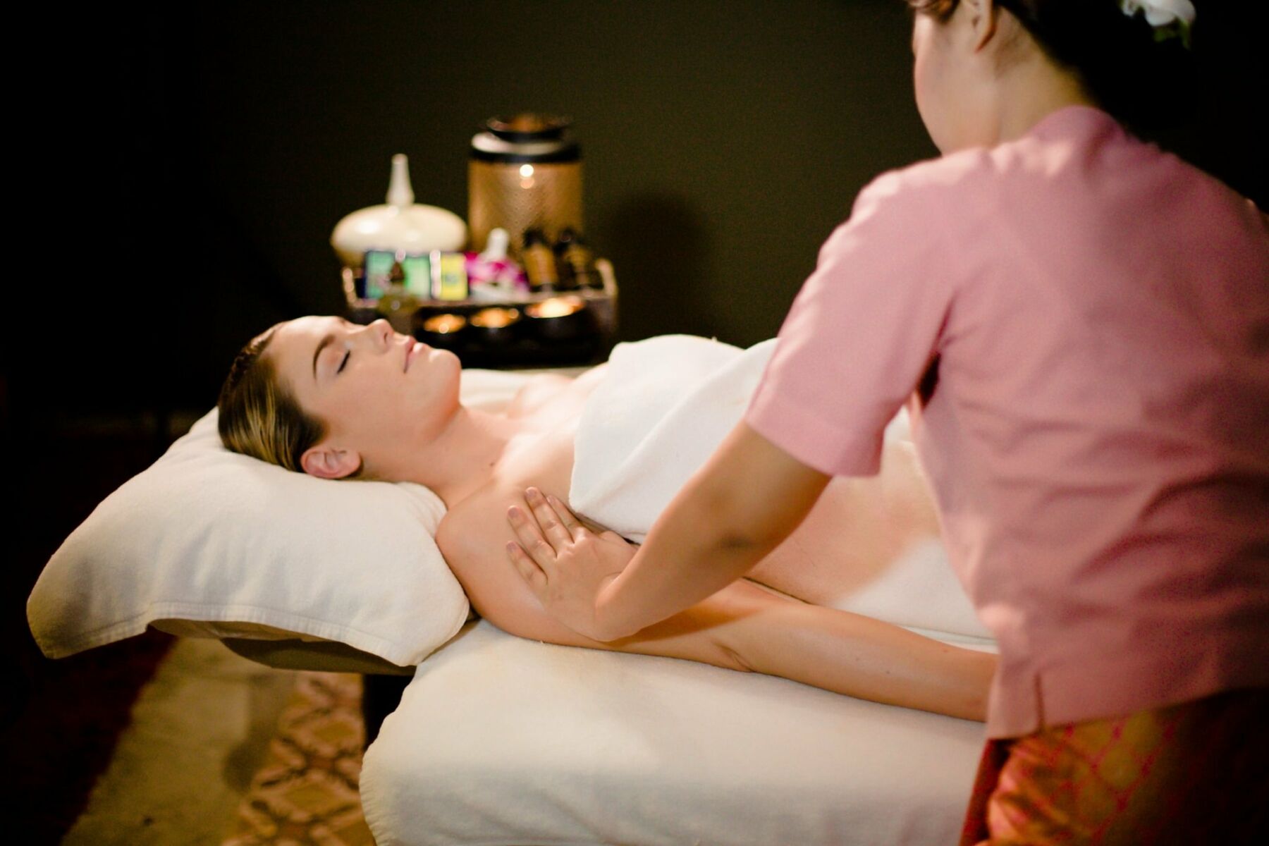 A therapist performing body massage on a caucasian woman at Dusita Spa, Koh Samui