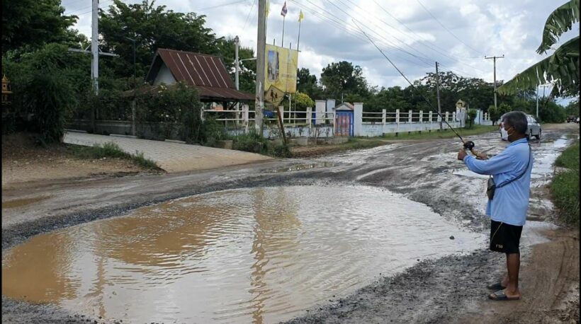 Man goes fishing in the road to prove a point in northeast Thailand