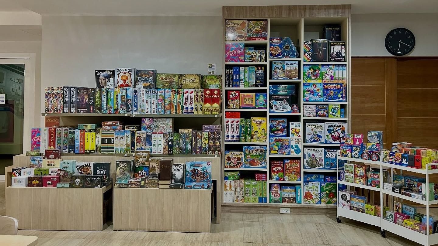 Shelves full of board games at More Than a Game Cafe Bangkok
