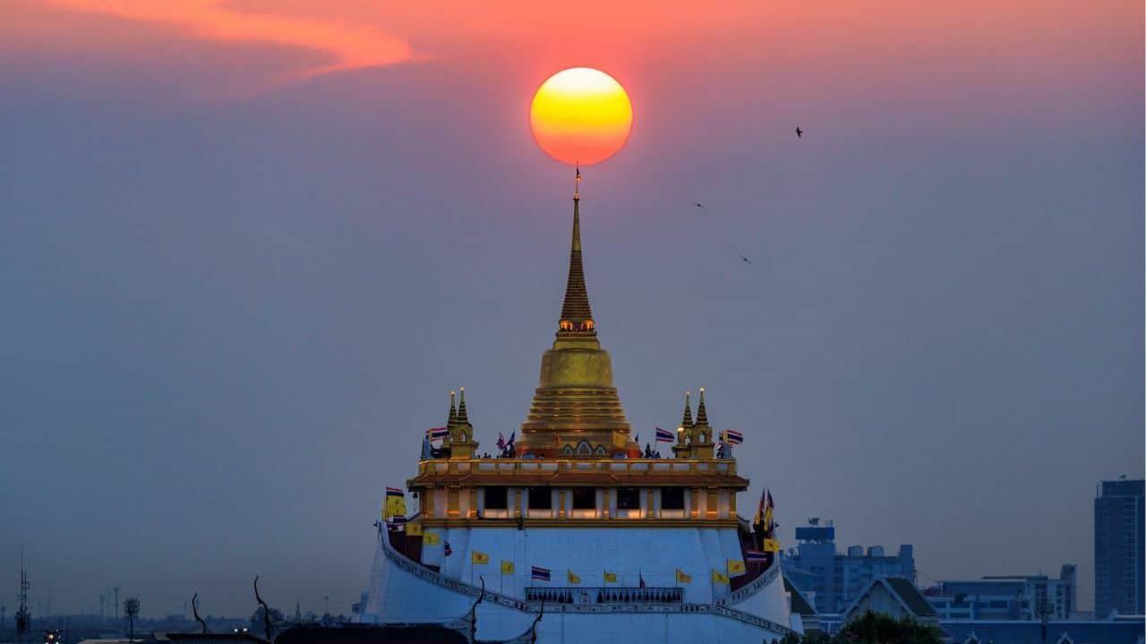 A perfectly times photo of the sun above The Golden Mount at Wat Saket
