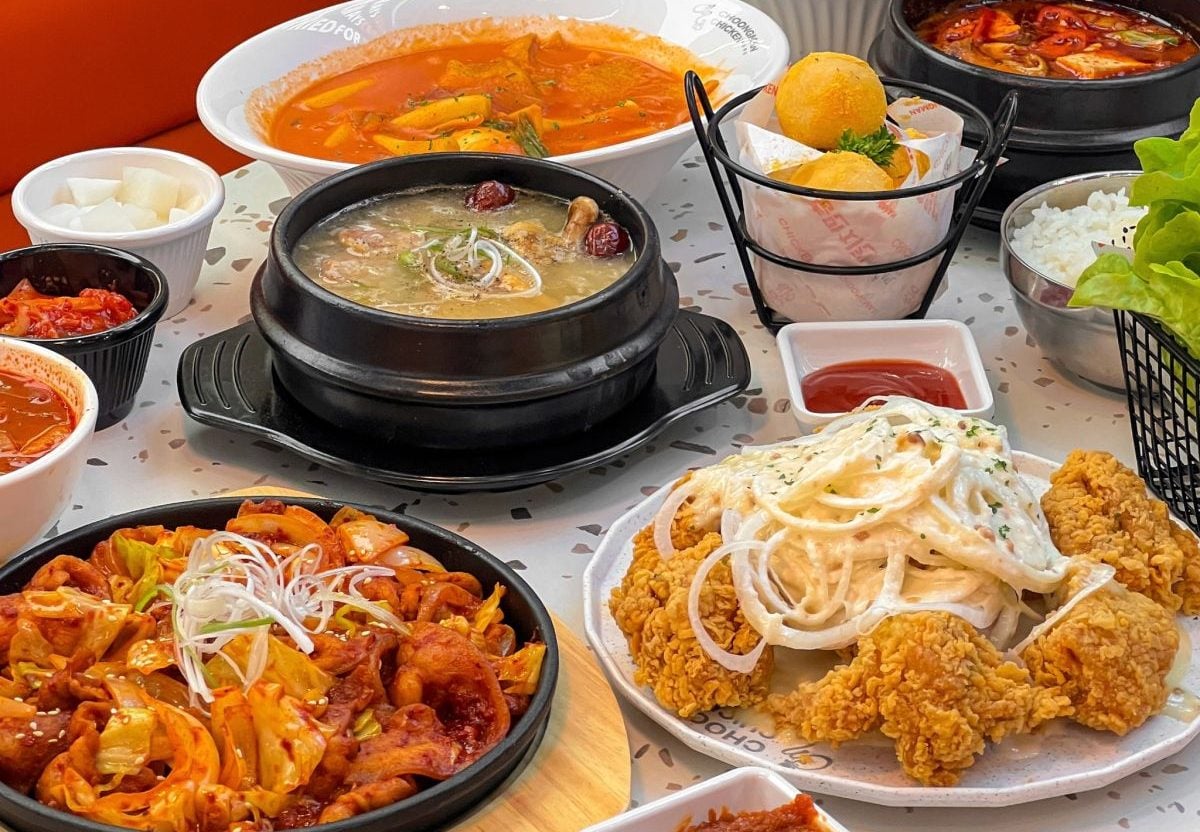 A table full of Korean food at Choongman Chicken, Bangkok.