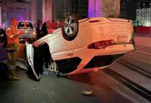 Speeding car flips over after taxi cuts in front at Bangkok traffic light