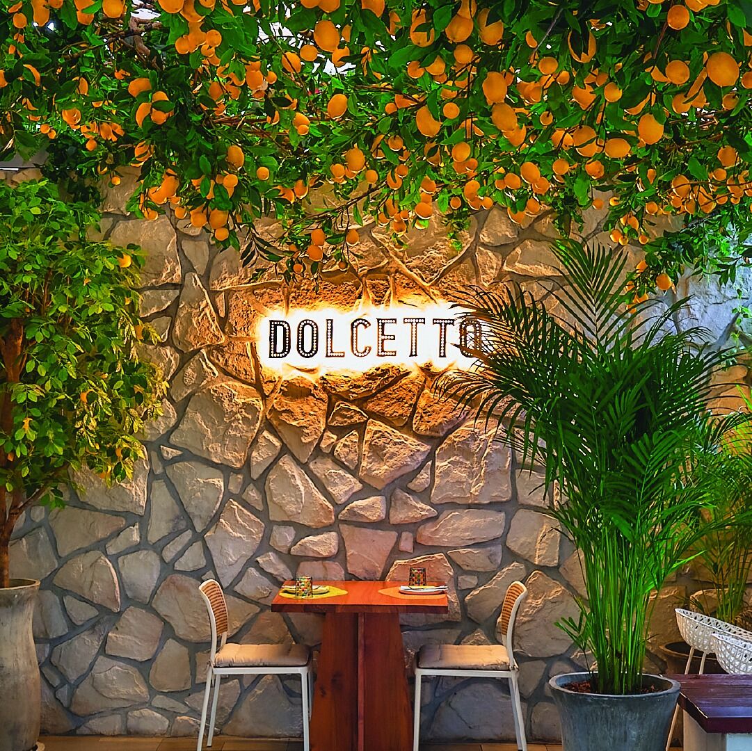 A cafe in Bangkok with an Italian Theme and fake orange trees