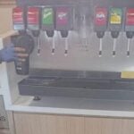 Delivery rider helps himself to water dispenser in Thai restaurant | Thaiger