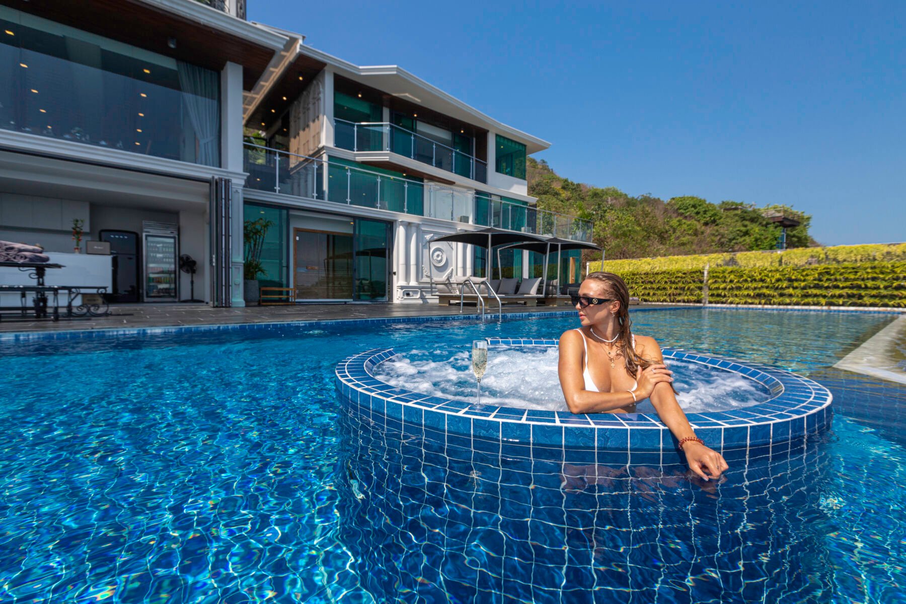 A girl soaking in a pool of a luxury villa in Phuket, Thailand