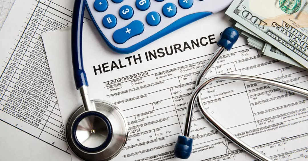 Image of a health insurance application form with a stethoscope, calculator, and some US dollars