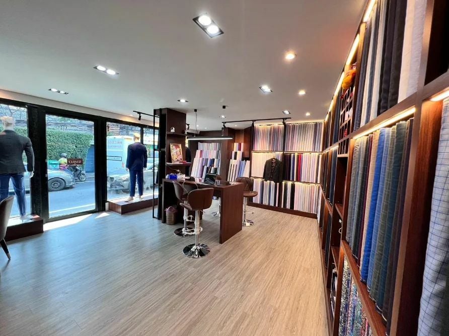 A bespoke tailor shope in Bangkok with fabrics neatly lined up on shelves - Class Bespoke Tailor Bangkok 