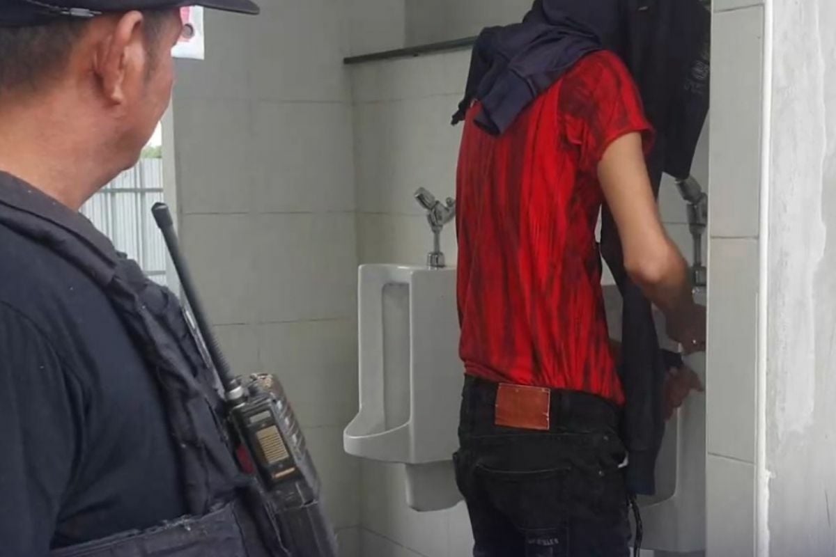 Gay voyeur caught filming truck driver in petrol station bathroom 