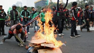 Indonesian motorcycle taxi drivers strike for fair pay