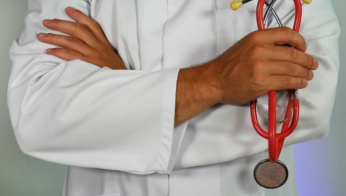 Health insurance and doctor holding an equipment