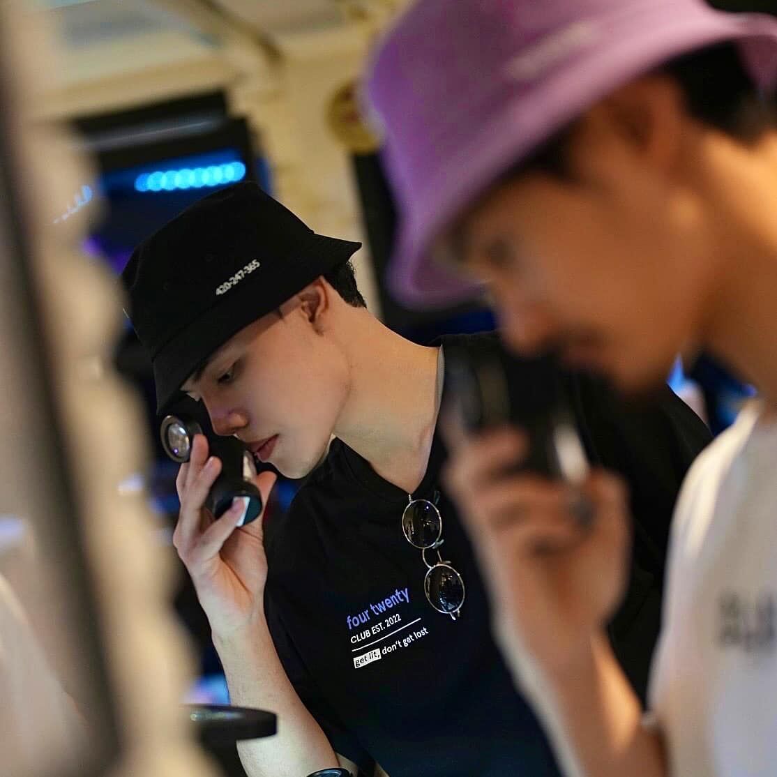 Two men sniffing legal cannabis jars at Four Twenty Thailand