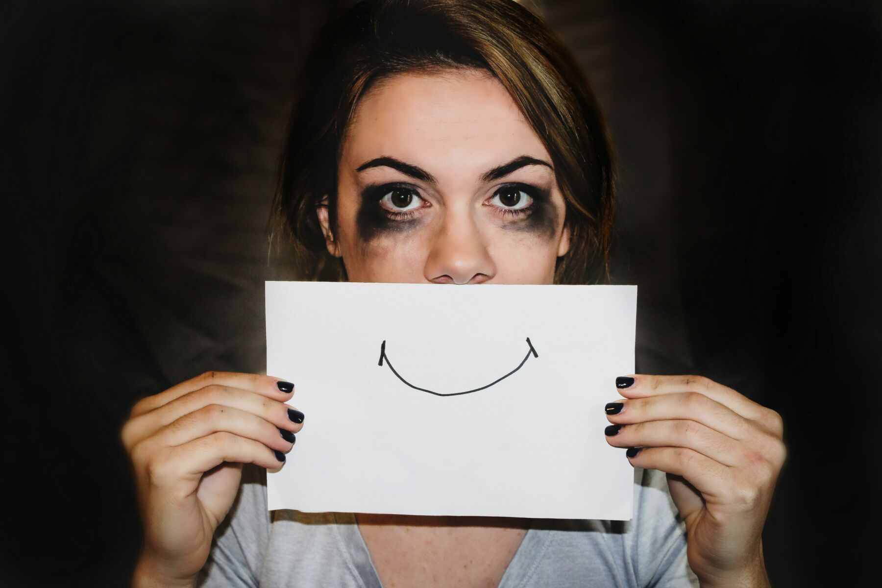 Image of a girl pretending to smile 