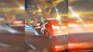 Orange taxi carries motorcycle down Rama II Road, sparks outrage