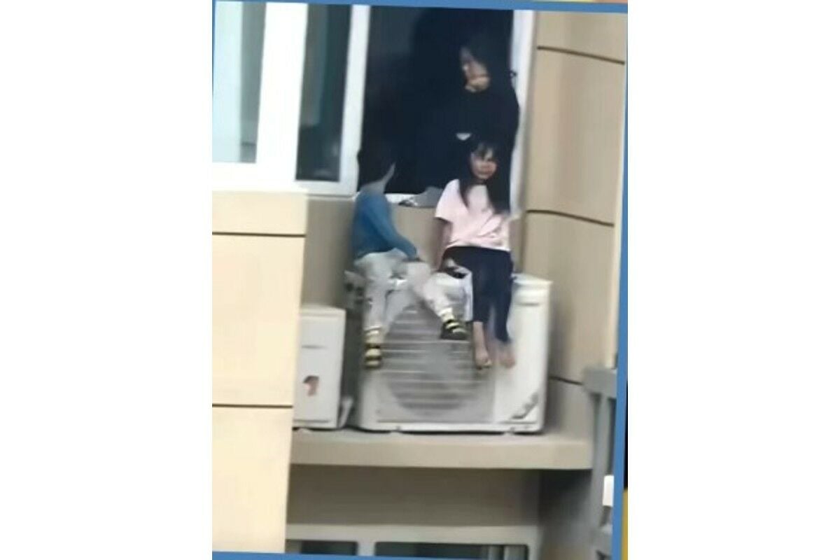 Chinese woman perches kids on 23rd-floor air con amid argument